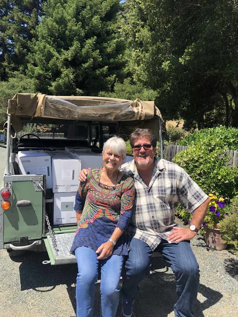 Patricia Lester and Frank on back of Jeep