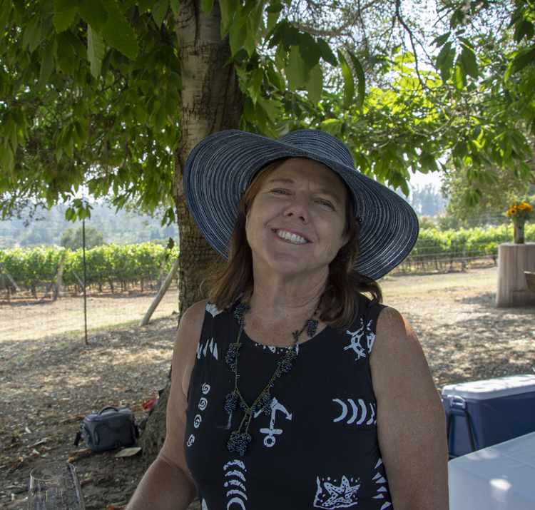 Prudy in a hat in the vineyard